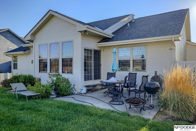 15930 Grebe St, Bennington, NE 68007 - rear view of property featuring a fire pit, a yard, a shingled roof, and a patio area
