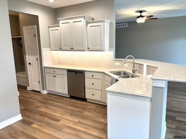 221 Briarwood Ln, Seward, NE 68434 - kitchen with dishwasher, a sink, a peninsula, ceiling fan, and decorative backsplash