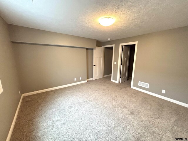 221 Briarwood Ln, Seward, NE 68434 - unfurnished bedroom with baseboards, carpet, a textured ceiling, and a closet
