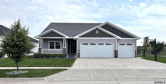 221 Briarwood Ln, Seward, NE 68434 - craftsman inspired home featuring an attached garage, concrete driveway, covered porch, and stone siding