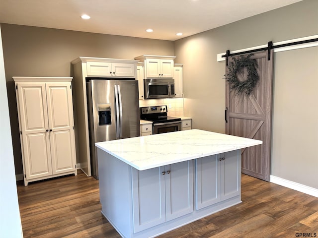 221 Briarwood Ln, Seward, NE 68434 - kitchen featuring appliances with stainless steel finishes, dark wood-type flooring, a kitchen island, light stone counters, and recessed lighting