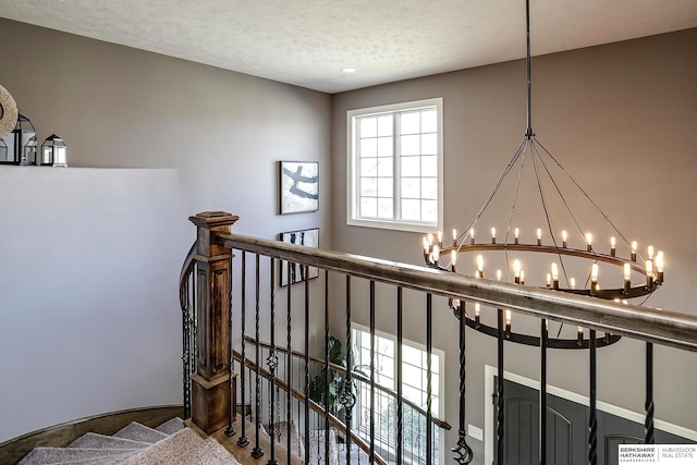 1809 S 220th Ave, Omaha, NE 68022 - stairway featuring a chandelier and a textured ceiling
