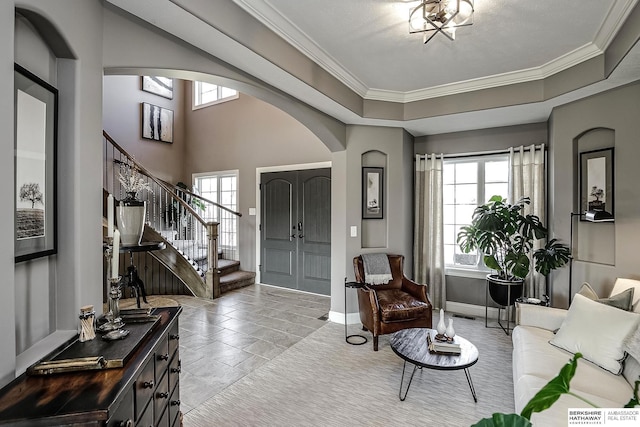 1809 S 220th Ave, Omaha, NE 68022 - foyer featuring arched walkways, stairway, ornamental molding, and a tray ceiling