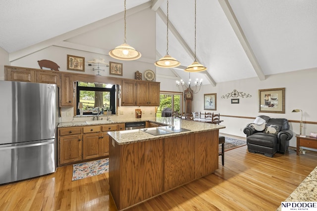 2723 Eagle Dr, Fremont, NE 68028 - kitchen with appliances with stainless steel finishes, brown cabinets, a chandelier, a breakfast bar area, and light wood-style flooring