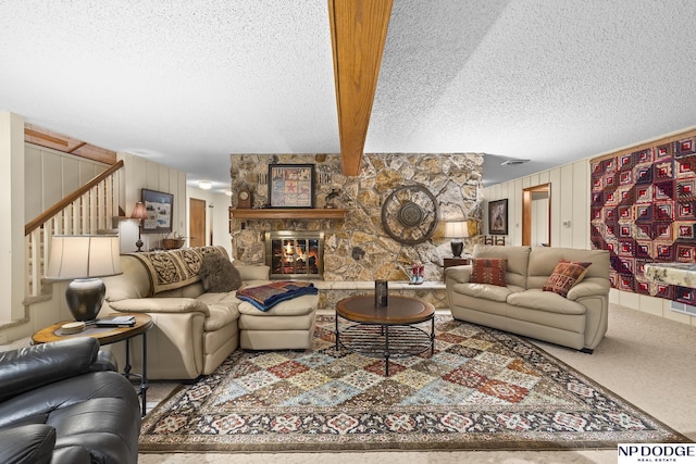 2723 Eagle Dr, Fremont, NE 68028 - living area featuring a textured ceiling, stairs, a fireplace, and carpet floors