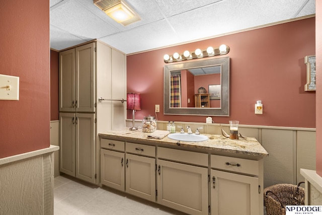 2723 Eagle Dr, Fremont, NE 68028 - bathroom with vanity, tile patterned floors, and a wainscoted wall