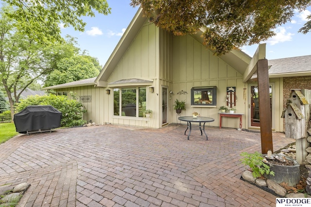 2723 Eagle Dr, Fremont, NE 68028 - rear view of house featuring a patio, board and batten siding, and a shingled roof