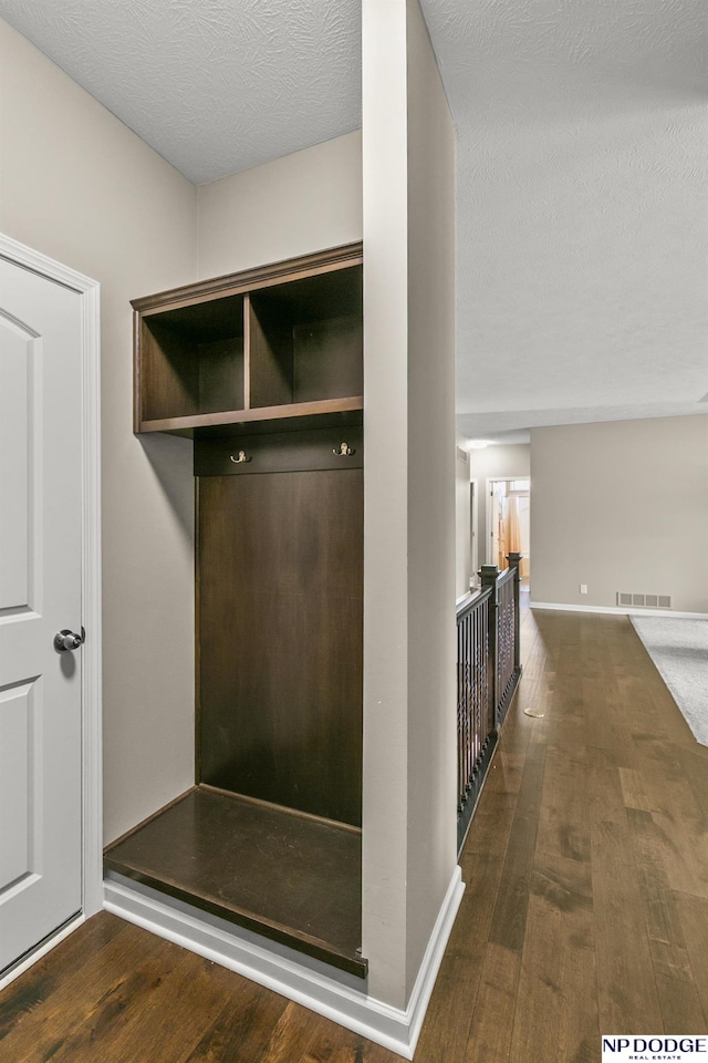 15301 Kansas Ave, Omaha, NE 68116 - mudroom with wood finished floors, baseboards, and a textured ceiling