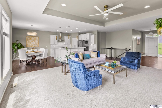 15301 Kansas Ave, Omaha, NE 68116 - living room with ceiling fan, recessed lighting, carpet, a tray ceiling, and baseboards