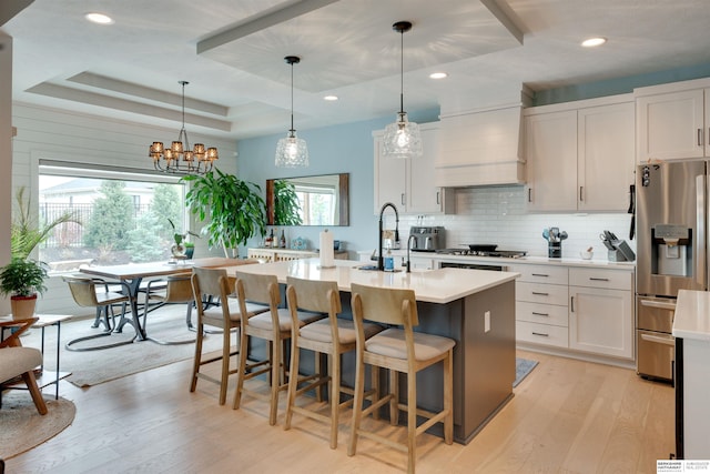 11511 S 190th St, Gretna, NE 68028 - kitchen featuring stainless steel refrigerator with ice dispenser, light wood finished floors, a tray ceiling, light countertops, and recessed lighting