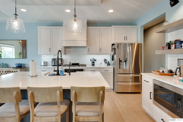 11511 S 190th St, Gretna, NE 68028 - kitchen with appliances with stainless steel finishes, tasteful backsplash, light wood-type flooring, white cabinetry, and recessed lighting