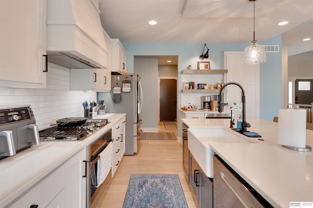 11511 S 190th St, Gretna, NE 68028 - kitchen with custom range hood, appliances with stainless steel finishes, a sink, white cabinetry, and light countertops