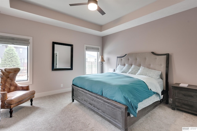 11511 S 190th St, Gretna, NE 68028 - carpeted bedroom with multiple windows, baseboards, a tray ceiling, and a ceiling fan