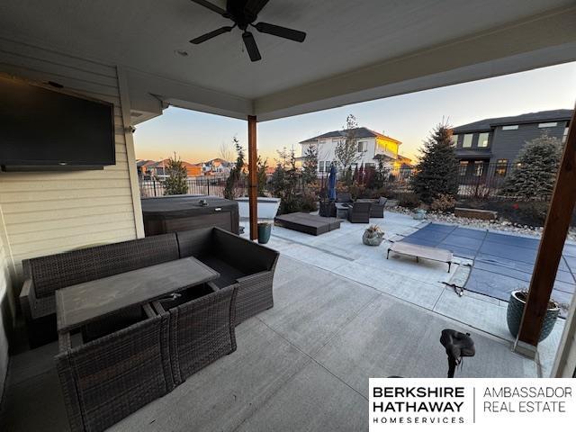 11511 S 190th St, Gretna, NE 68028 - patio terrace at dusk featuring a hot tub, a patio, an outdoor hangout area, and ceiling fan