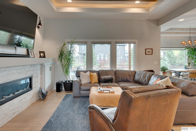 11511 S 190th St, Gretna, NE 68028 - living area featuring a tray ceiling, light wood-style flooring, recessed lighting, a fireplace, and a chandelier
