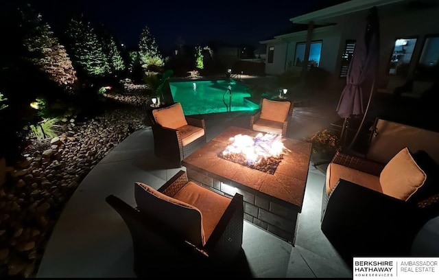 11511 S 190th St, Gretna, NE 68028 - pool at night featuring a fire pit, a patio, and an outdoor pool