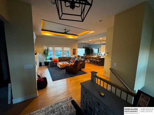 11511 S 190th St, Gretna, NE 68028 - living area with a ceiling fan, light wood-style floors, a tray ceiling, recessed lighting, and baseboards