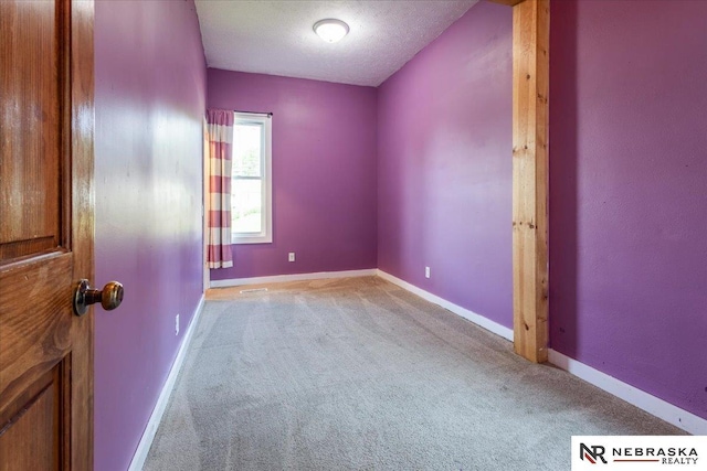 610 S 10th St, Plattsmouth, NE 68048 - unfurnished room featuring light colored carpet, baseboards, and a textured ceiling
