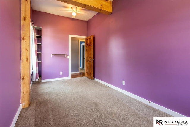 610 S 10th St, Plattsmouth, NE 68048 - unfurnished bedroom featuring carpet flooring, baseboards, and beamed ceiling