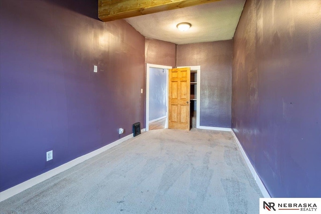 610 S 10th St, Plattsmouth, NE 68048 - carpeted empty room with baseboards and beam ceiling