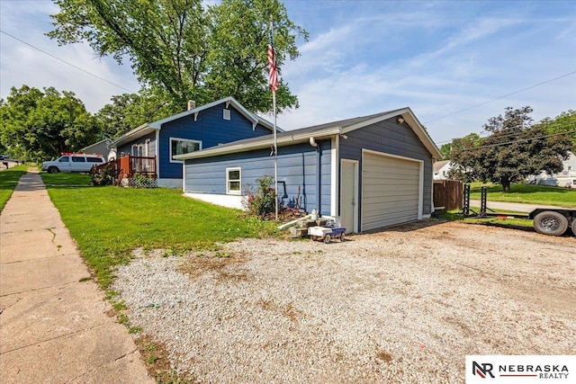 610 S 10th St, Plattsmouth, NE 68048 - view of home's exterior with dirt driveway, a yard, and a detached garage