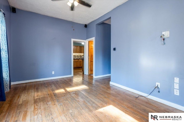 610 S 10th St, Plattsmouth, NE 68048 - spare room featuring a ceiling fan, wood finished floors, and baseboards