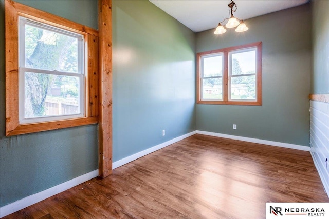 610 S 10th St, Plattsmouth, NE 68048 - spare room with wood finished floors, a chandelier, and baseboards