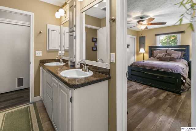 S-44 Poehling Ln, Fremont, NE 68025 - bathroom with ensuite bath, double vanity, wood finished floors, and a ceiling fan