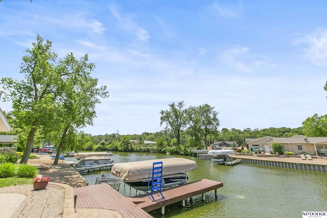 S-44 Poehling Ln, Fremont, NE 68025 - dock area featuring boat lift, a water view, and view of scattered trees