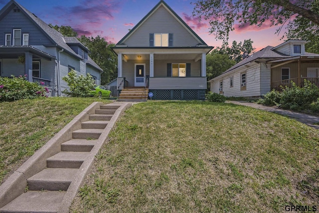 2945 N 59th St, Omaha, NE 68104 - view of front of house featuring covered porch and a front lawn