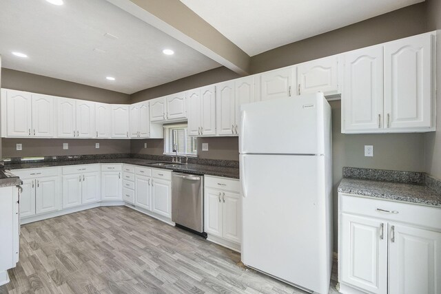 2945 N 59th St, Omaha, NE 68104 - kitchen with freestanding refrigerator, stainless steel dishwasher, a sink, white cabinets, and recessed lighting