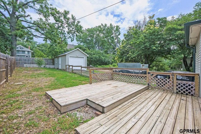 2945 N 59th St, Omaha, NE 68104 - deck featuring a garage, an outdoor structure, and view of scattered trees