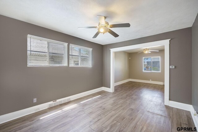 2945 N 59th St, Omaha, NE 68104 - unfurnished room featuring ceiling fan, wood finished floors, and baseboards