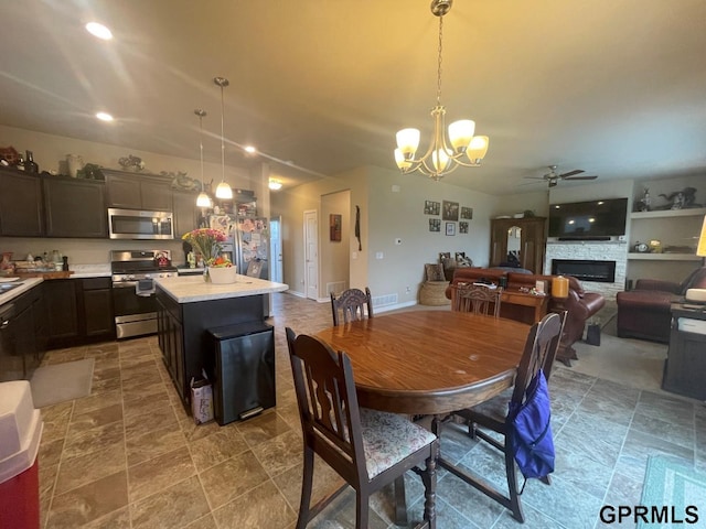 14316 S 19th Cir, Bellevue, NE 68123 - dining area with a ceiling fan, a chandelier, a stone fireplace, stone finish floors, and recessed lighting