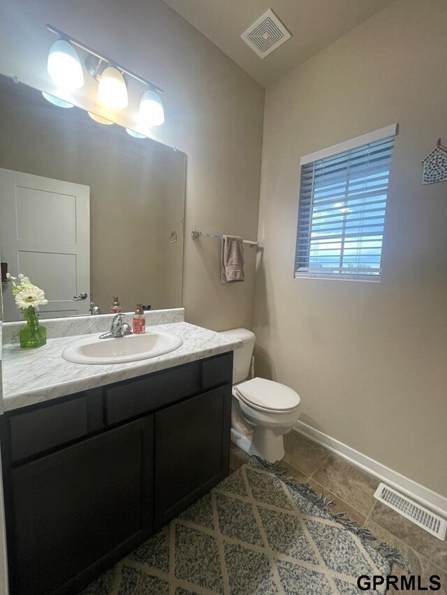 14316 S 19th Cir, Bellevue, NE 68123 - bathroom featuring vanity, toilet, baseboards, and tile patterned floors