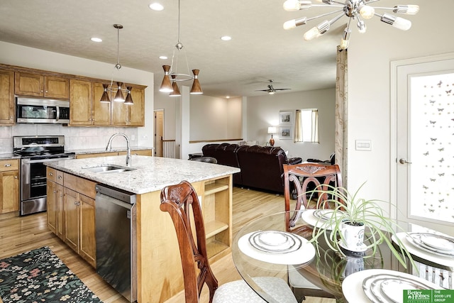 2627 N 166th St, Omaha, NE 68116 - kitchen featuring appliances with stainless steel finishes, a sink, light wood-style floors, backsplash, and recessed lighting
