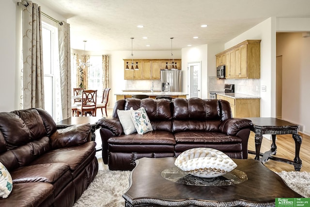 2627 N 166th St, Omaha, NE 68116 - living area with light wood-type flooring, recessed lighting, and baseboards
