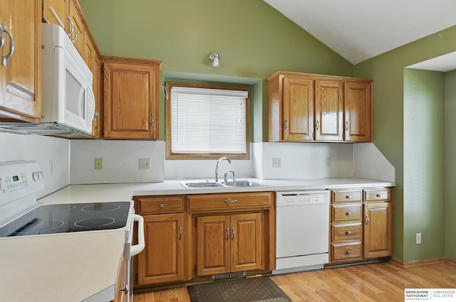 12335 Wirt St, Omaha, NE 68164 - kitchen with white appliances, a sink, lofted ceiling, light wood finished floors, and brown cabinets