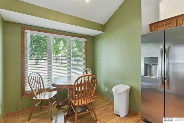 12335 Wirt St, Omaha, NE 68164 - dining space with vaulted ceiling, light wood finished floors, and baseboards