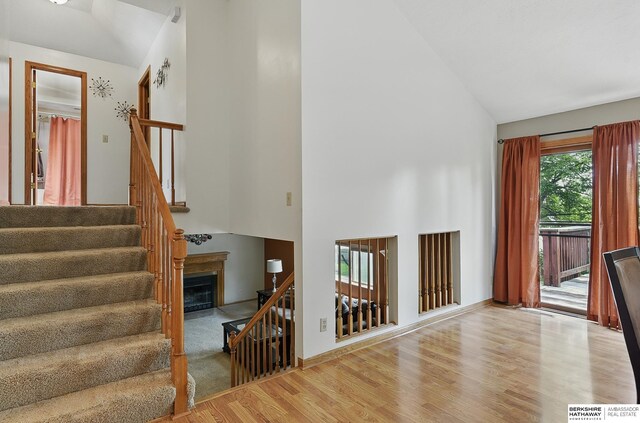 12335 Wirt St, Omaha, NE 68164 - stairway with high vaulted ceiling and wood finished floors