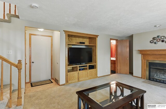 12335 Wirt St, Omaha, NE 68164 - living area with light carpet, stairway, a fireplace with flush hearth, a textured ceiling, and baseboards