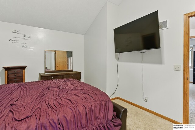 12335 Wirt St, Omaha, NE 68164 - carpeted bedroom featuring vaulted ceiling and baseboards
