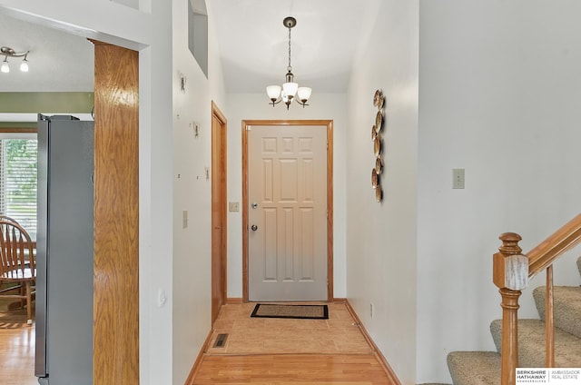 12335 Wirt St, Omaha, NE 68164 - entrance foyer featuring a chandelier, light wood finished floors, stairs, and baseboards