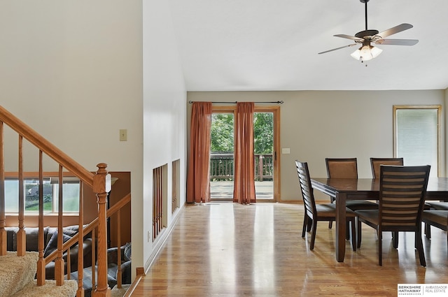 12335 Wirt St, Omaha, NE 68164 - dining area with light wood finished floors, high vaulted ceiling, ceiling fan, and stairway