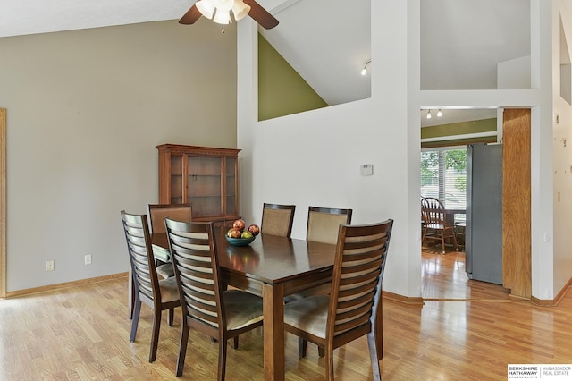 12335 Wirt St, Omaha, NE 68164 - dining area featuring high vaulted ceiling, a ceiling fan, light wood finished floors, baseboards, and rail lighting