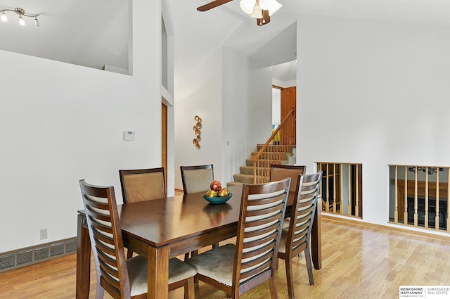 12335 Wirt St, Omaha, NE 68164 - dining space with a ceiling fan, light wood finished floors, stairway, and lofted ceiling
