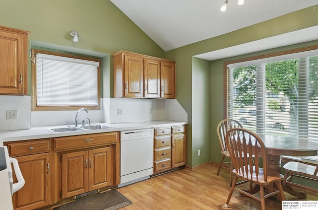 12335 Wirt St, Omaha, NE 68164 - kitchen with dishwasher, a sink, vaulted ceiling, light wood finished floors, and brown cabinetry