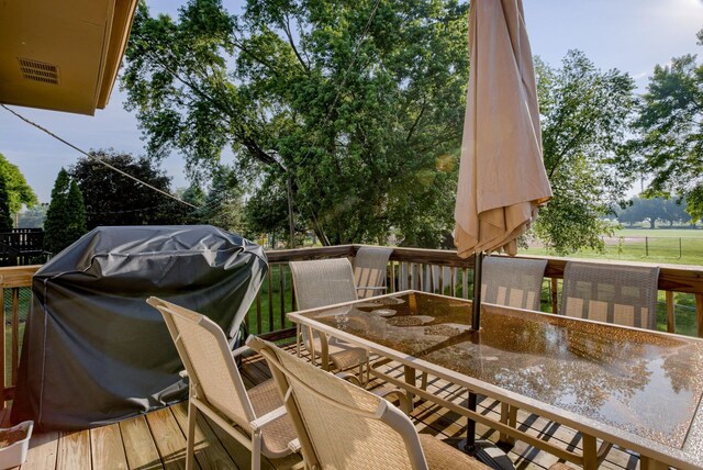 253 S 110th St, Omaha, NE 68154 - wooden terrace featuring outdoor dining area and view of wooded area