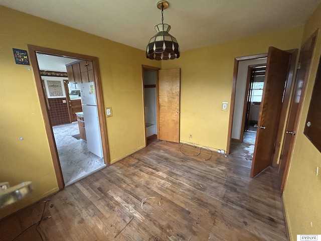 5329 N 47th St, Omaha, NE 68104 - unfurnished dining area with wood finished floors and a chandelier