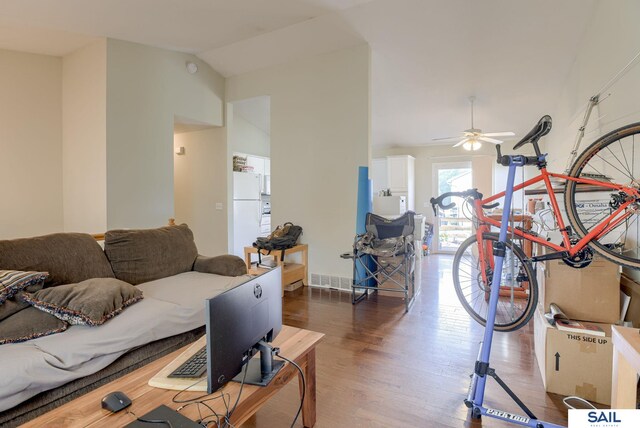 17103 Taylor St, Omaha, NE 68116 - living area with wood finished floors, vaulted ceiling, and a ceiling fan